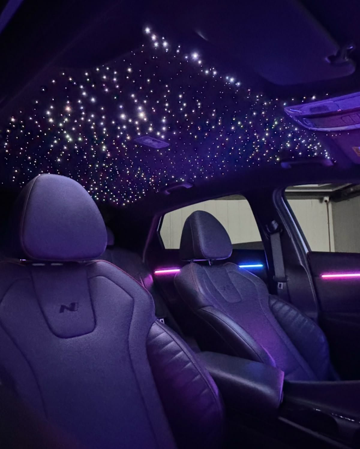 Car wrapped in colourful string lights